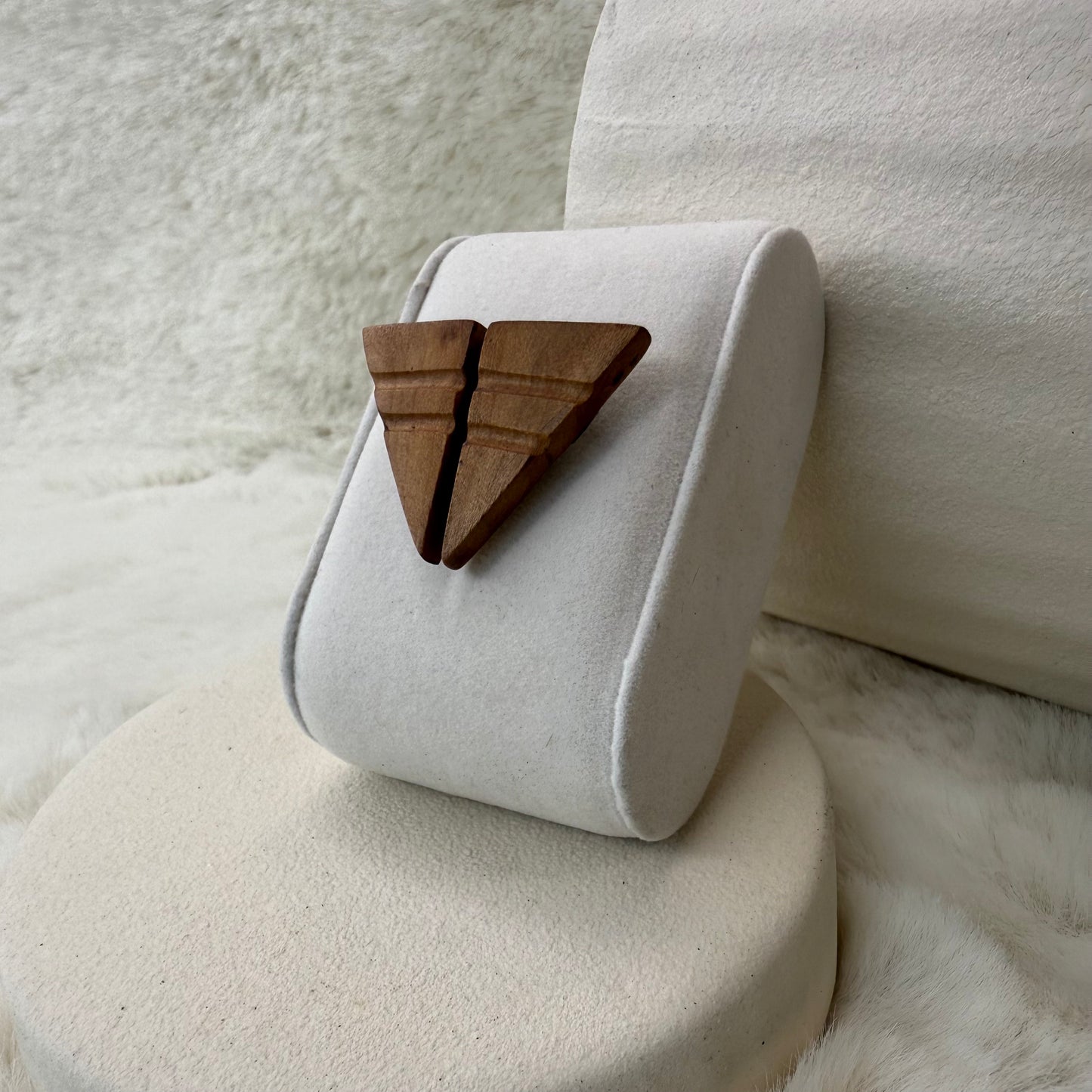 Minimalist apple wood earrings resting on hand for scale, showcasing lightweight design and compact size.