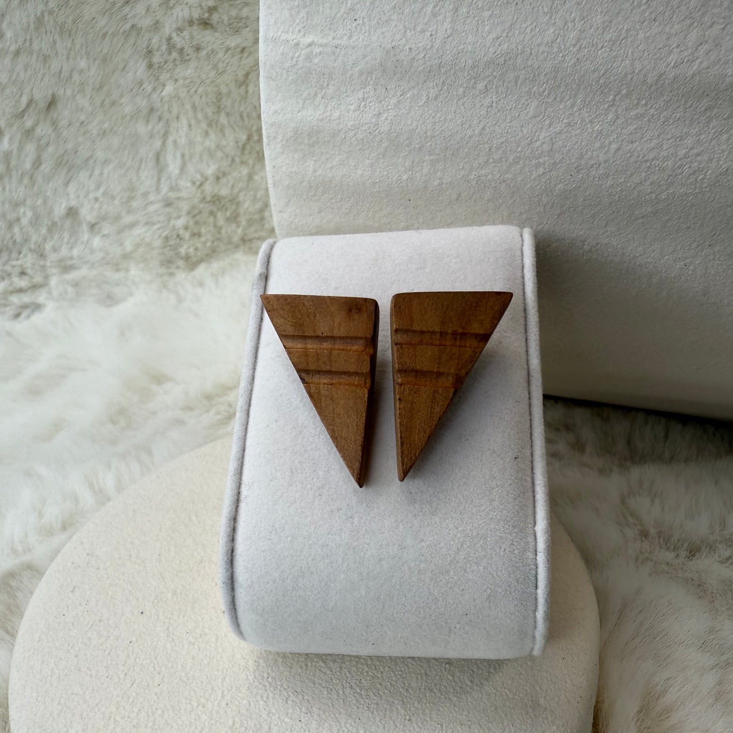 Handmade geometric triangle earrings crafted from natural apple wood, minimalist and eco-friendly design, displayed on a light background.