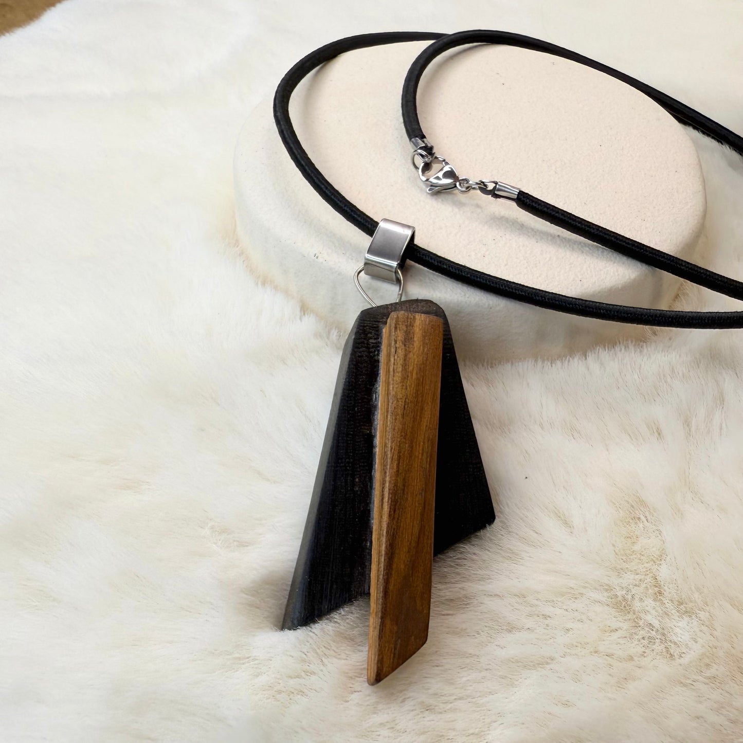 Handmade pendant necklace made from Irish bog oak and bog pine on black rubber cord