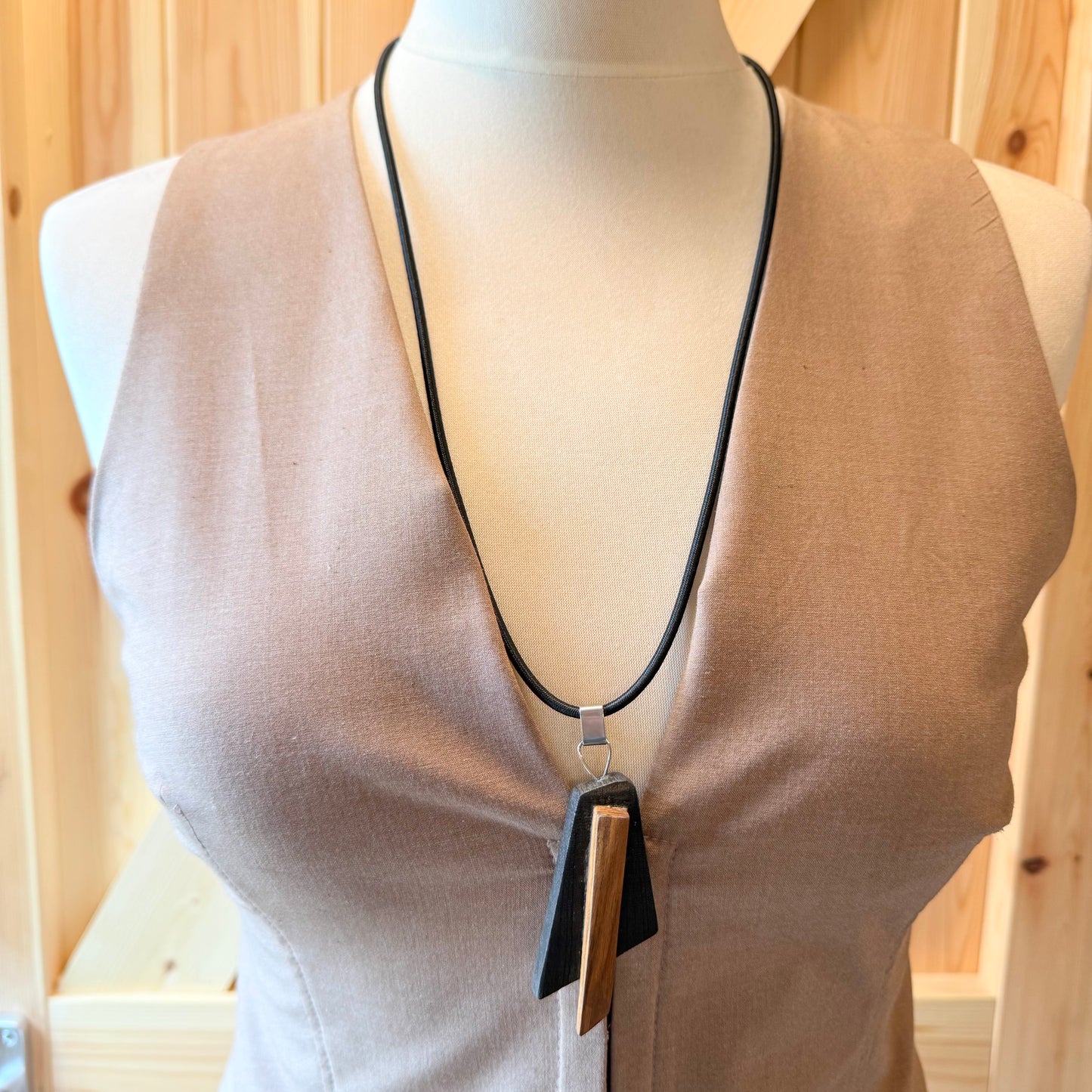 Side view of handcrafted bog wood necklace showing contrast of oak and pine