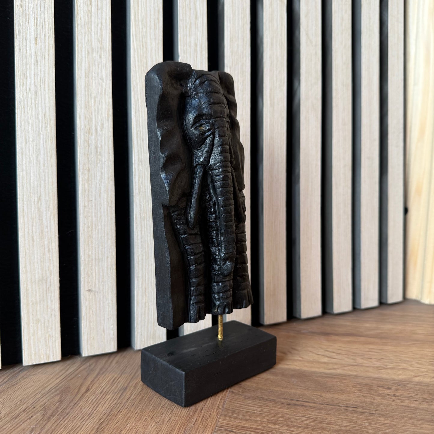 Close-up of dark wood elephant carving with visible bog oak grain