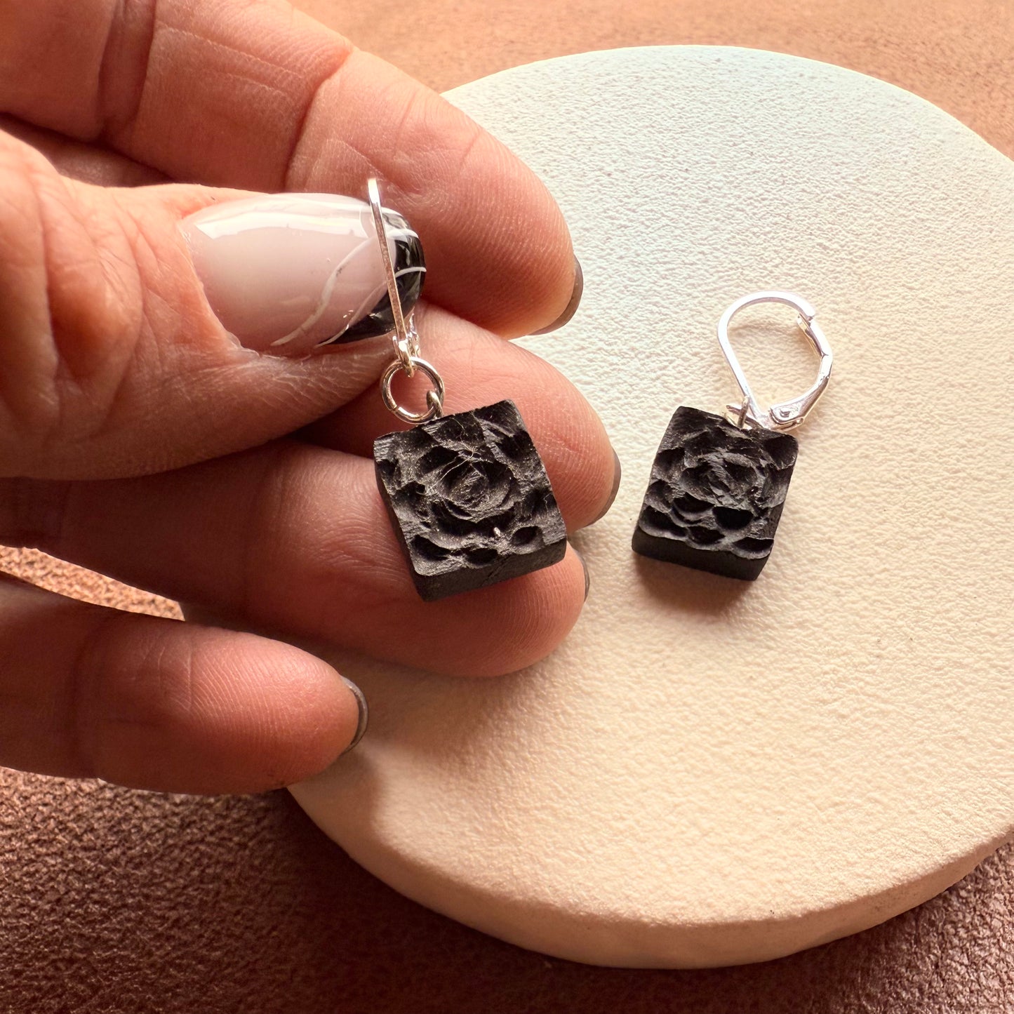 Dark oak earrings on minimalist jewelry tray