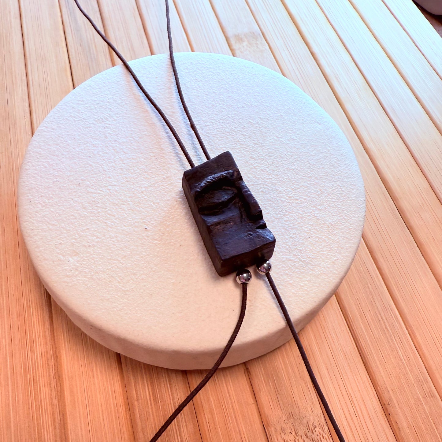 Natural wood pendant necklace symbolizing inner peace, handcrafted from rare bog oak