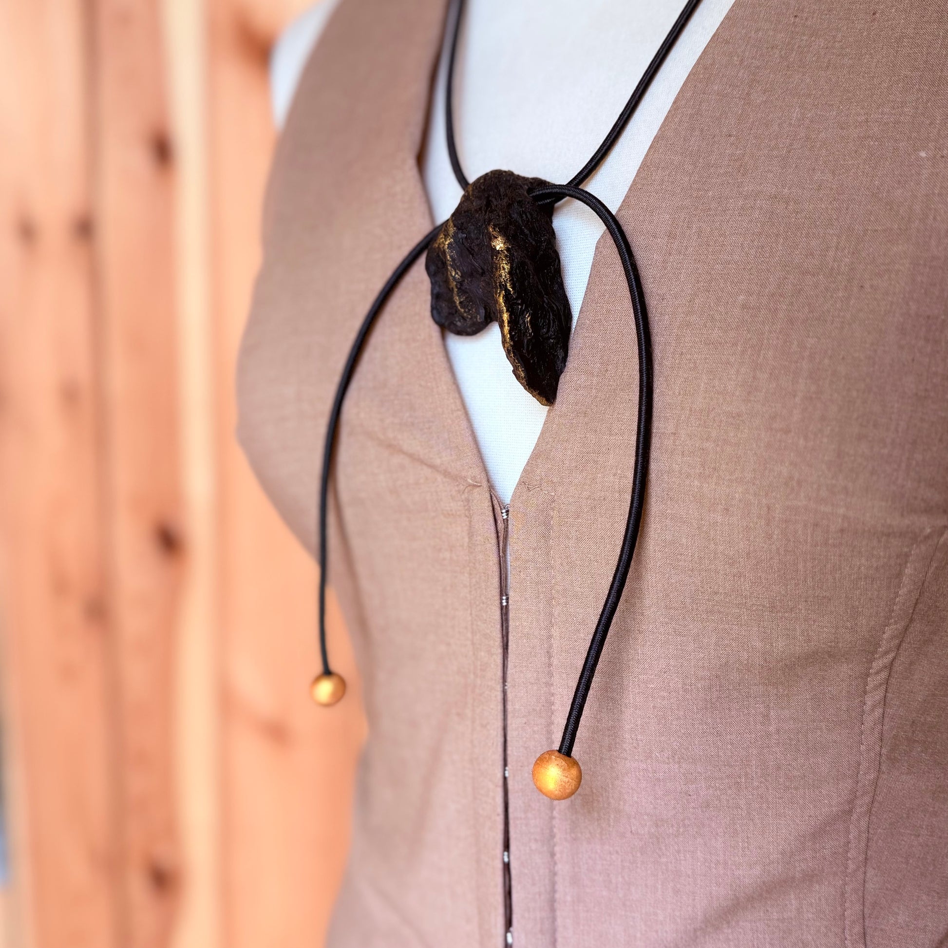 Handmade natural wood necklace featuring dark oak and gold details
