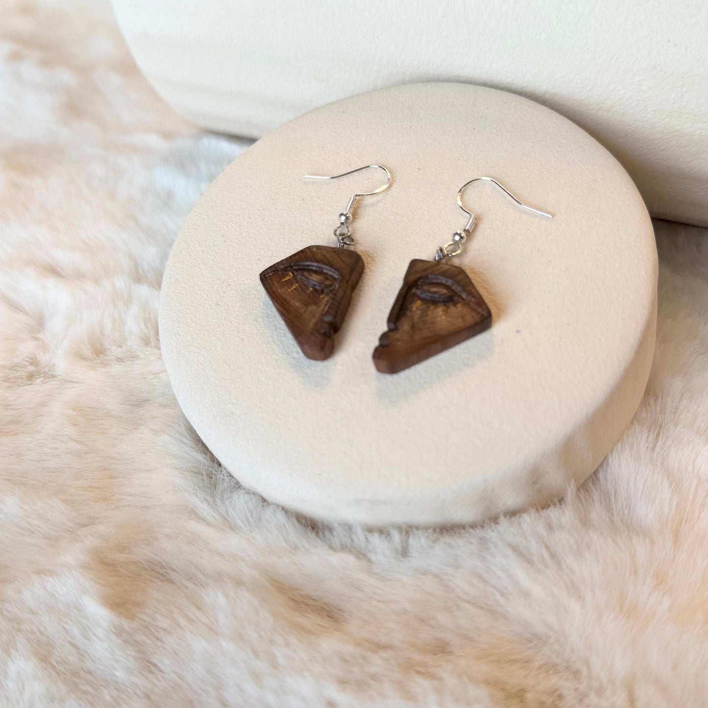 Pair of natural bog wood earrings on display
