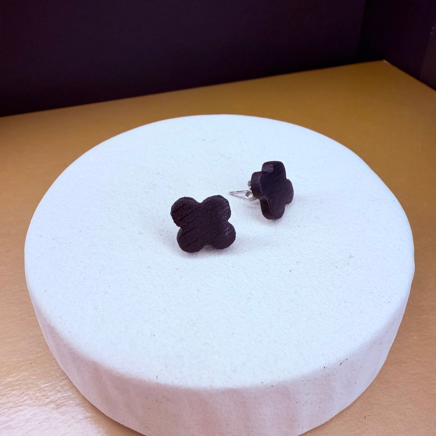Handcrafted bog oak stud earrings with a unique clover design, showcasing the natural dark wood grain.