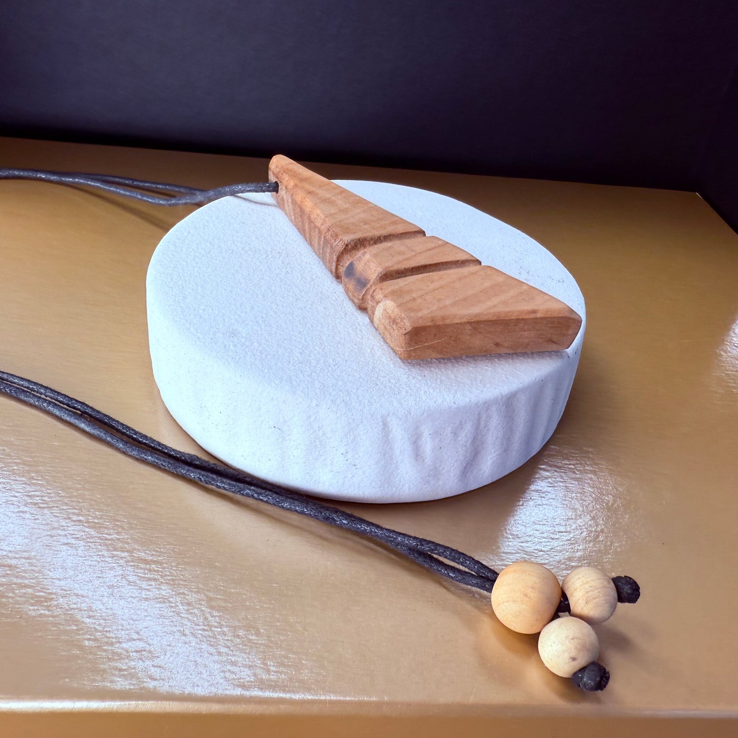 Natural wooden necklace styled with casual outfit, handmade apple wood pendant jewelry