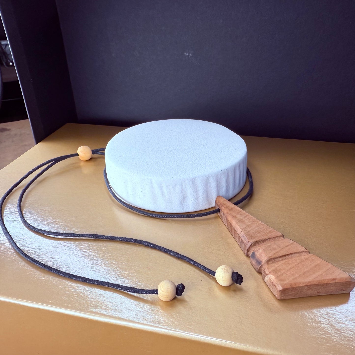 Handmade apple wood pendant necklace worn on neck, adjustable cord for versatile styling