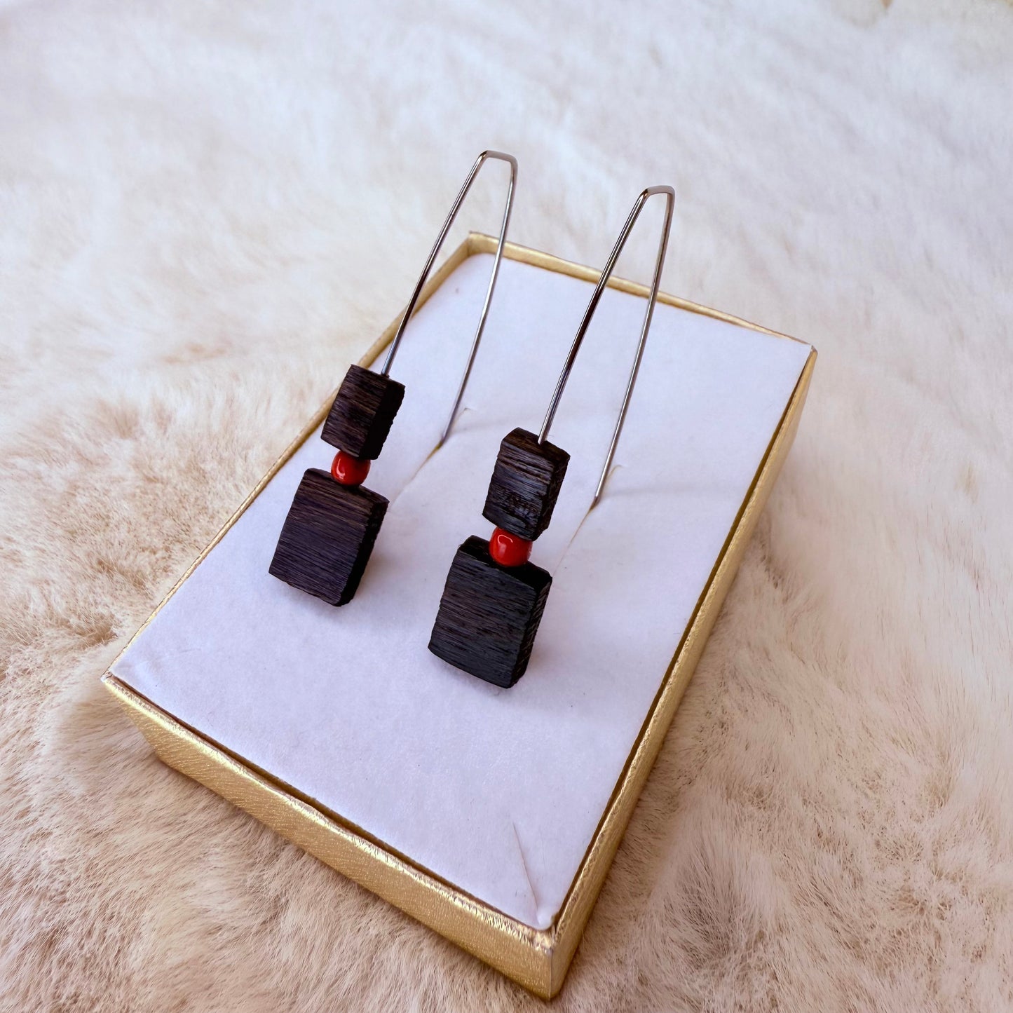 Black square earrings with red accents