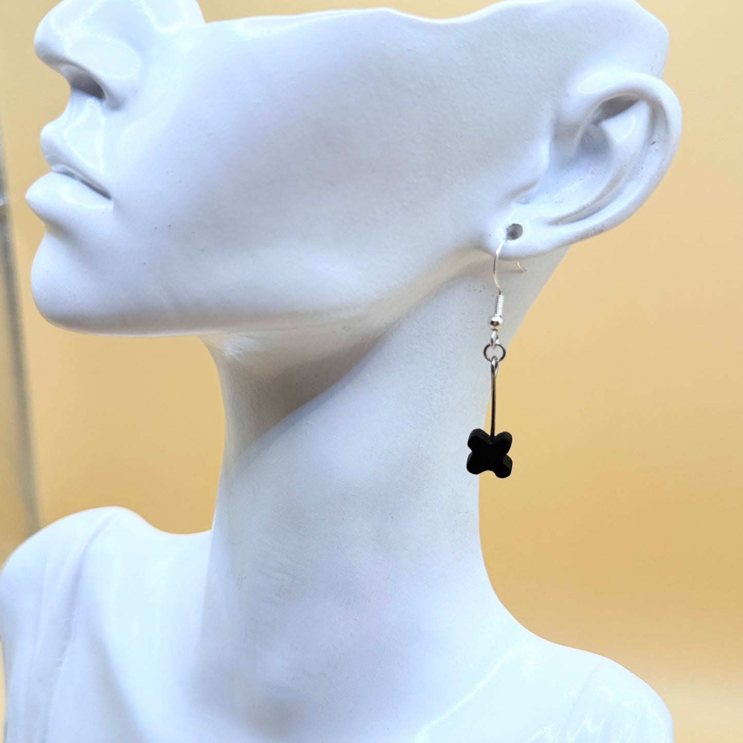 wearing a black flower-shaped earring
