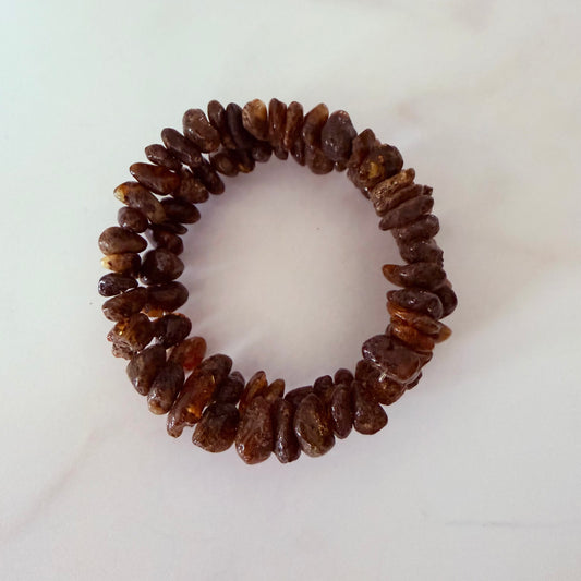 Brown beaded hair tie on a white background