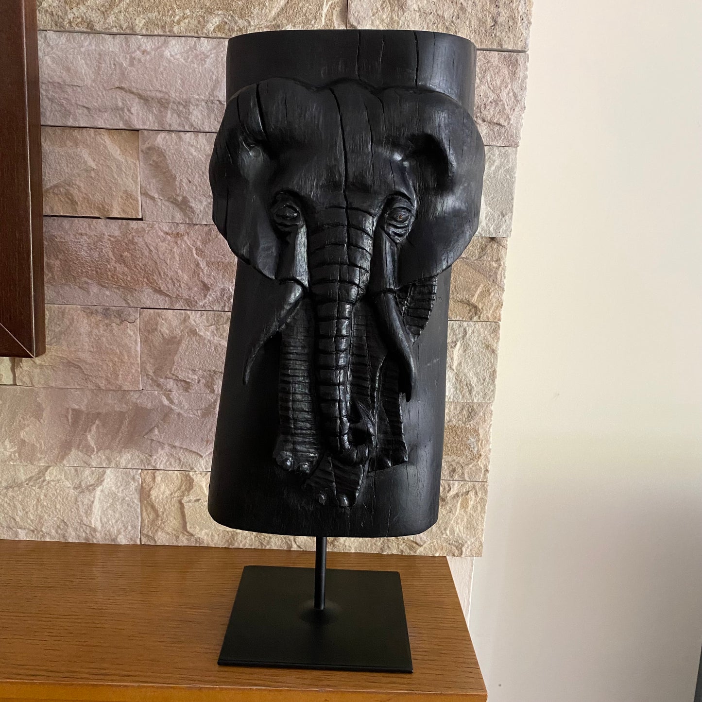 Irish Bog Oak Hand Carved Elephant Sculpture on a Black Metal Stand.