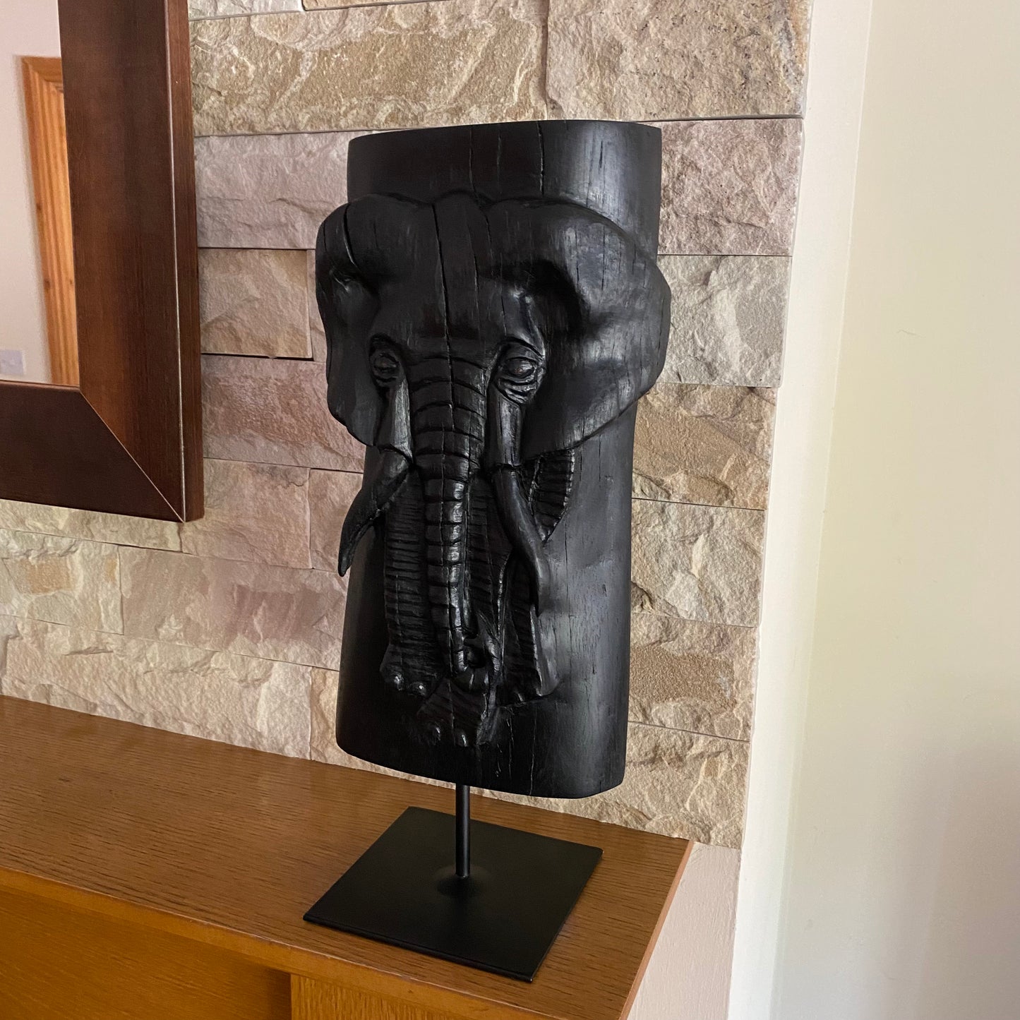 Irish Bog Oak Hand Carved Elephant Sculpture on a Black Metal Stand.