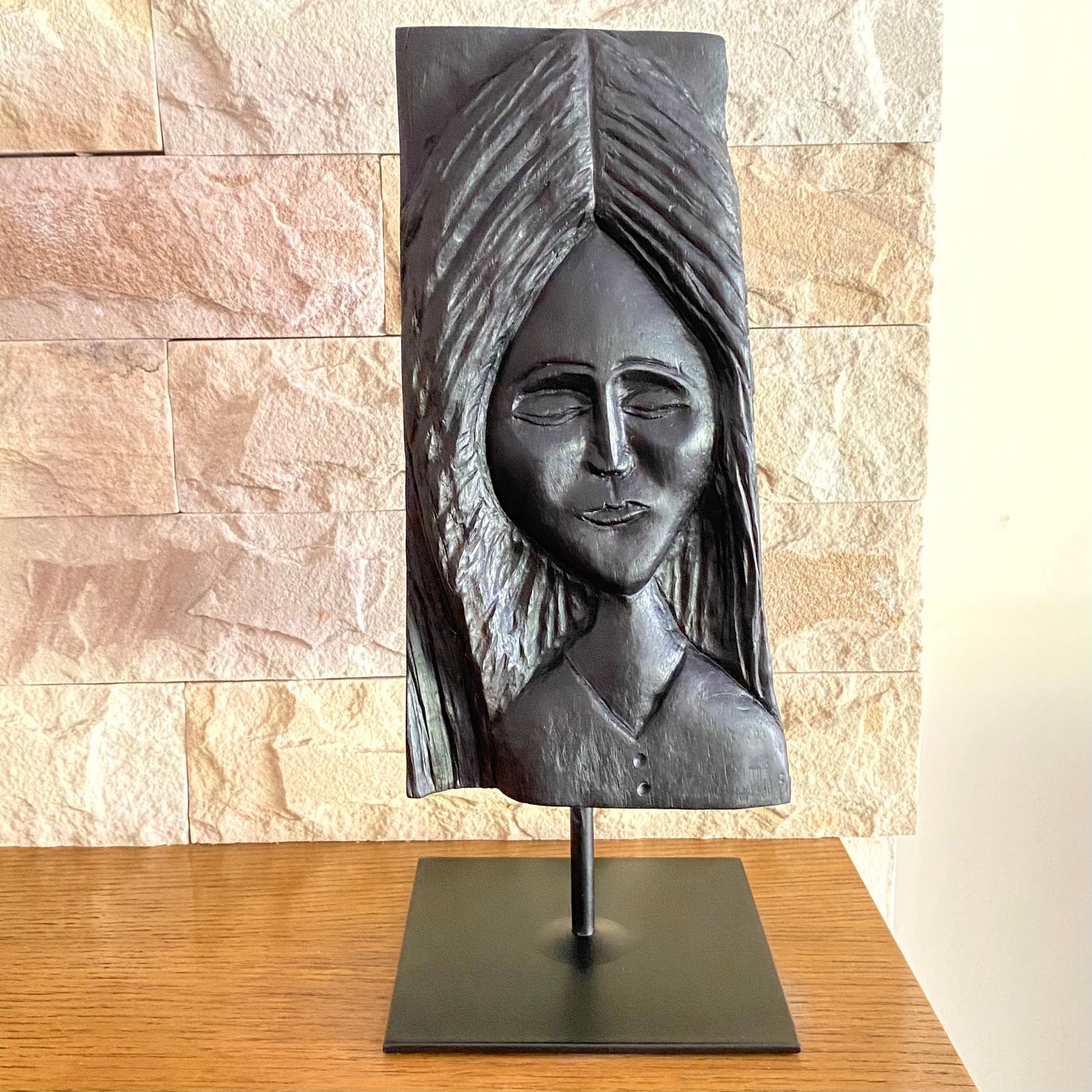 Irish Bog Oak Hand Carved Lady Sculpture on a Black Metal Stand.