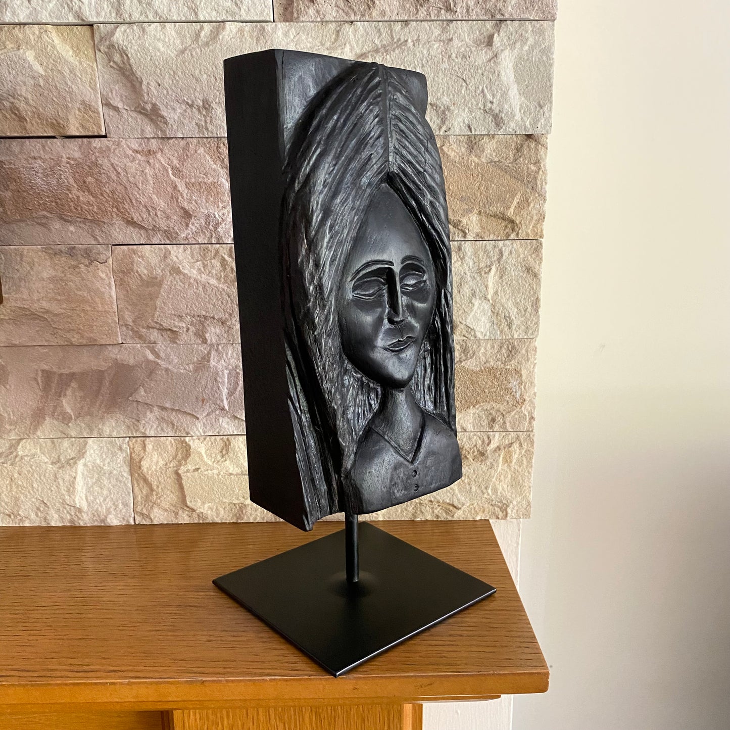 Irish Bog Oak Hand Carved Lady Sculpture on a Black Metal Stand.