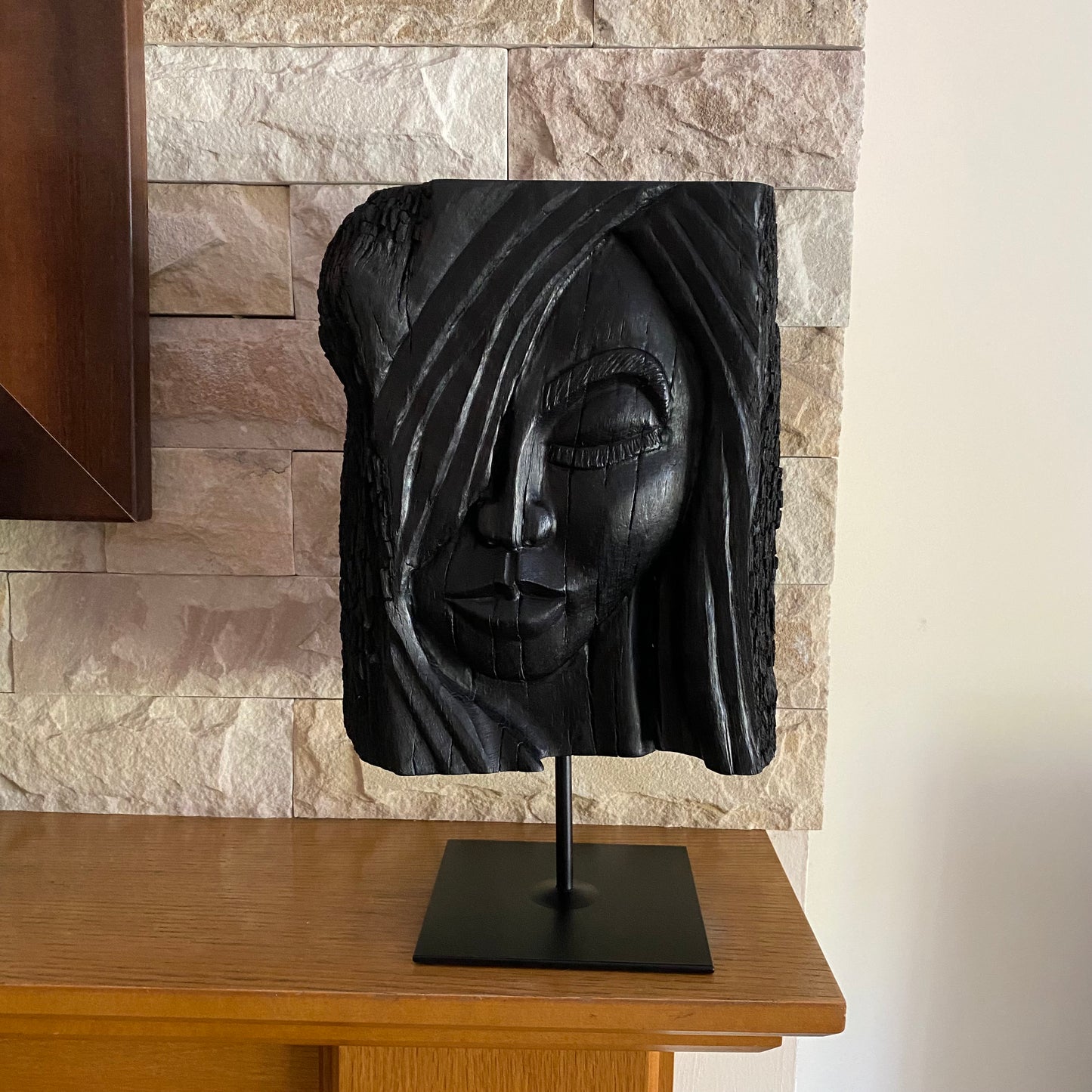 rish Bog Oak Hand Carved Woman Sculpture on a Black Metal Stand.