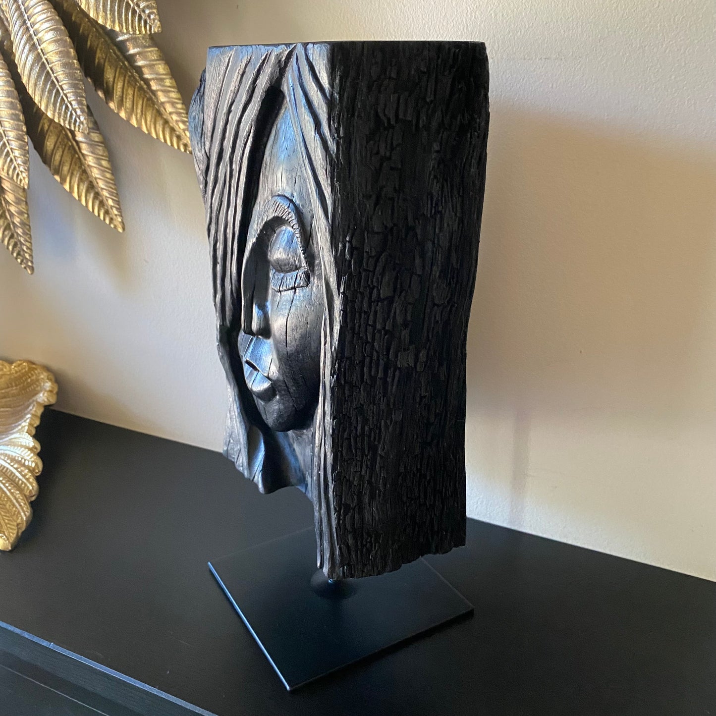 rish Bog Oak Hand Carved Woman Sculpture on a Black Metal Stand.