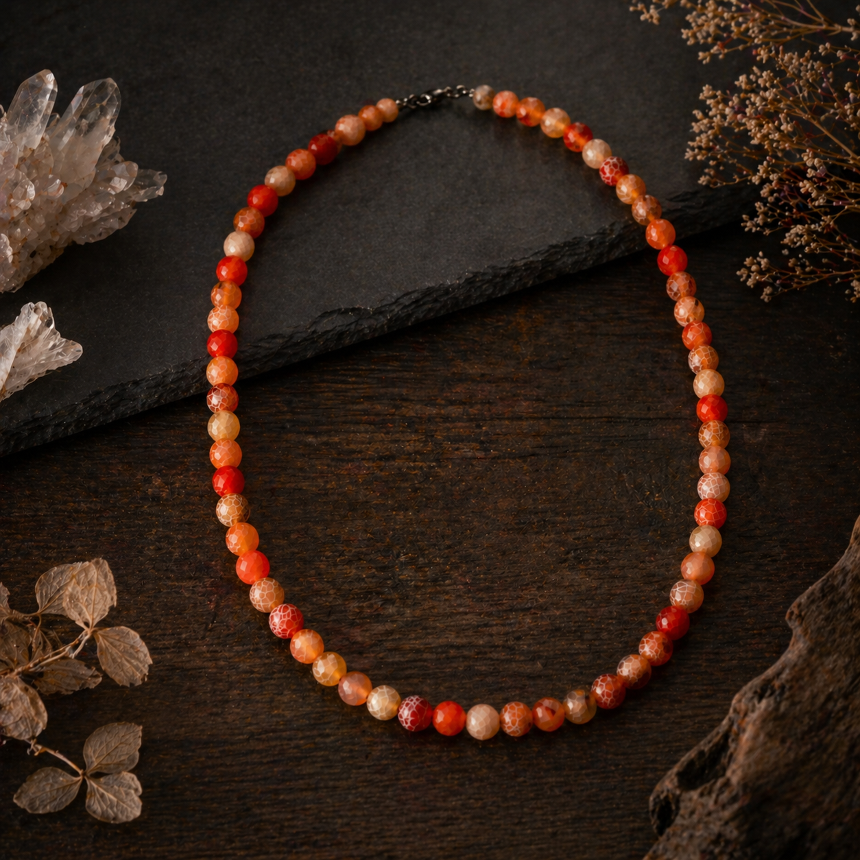Beaded necklace on a dark surface with decorative elements