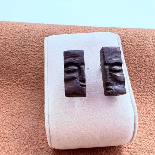 Hand-carved earrings made from ancient Irish bog oak wood, displayed on natural linen background.