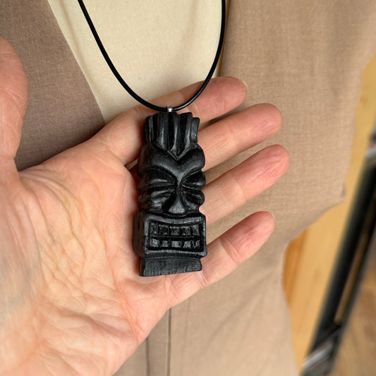Tiki necklace on leather cord worn as men's natural wood jewelry