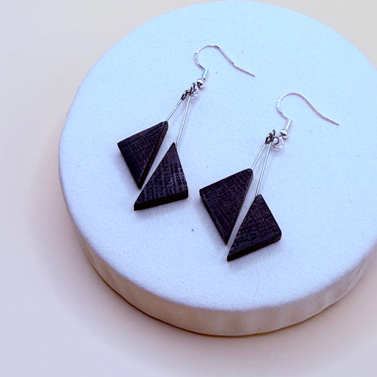Handmade bog oak triangle earrings on white display