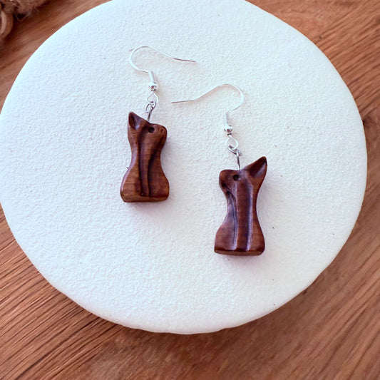 Handmade bog pine wooden earrings on display