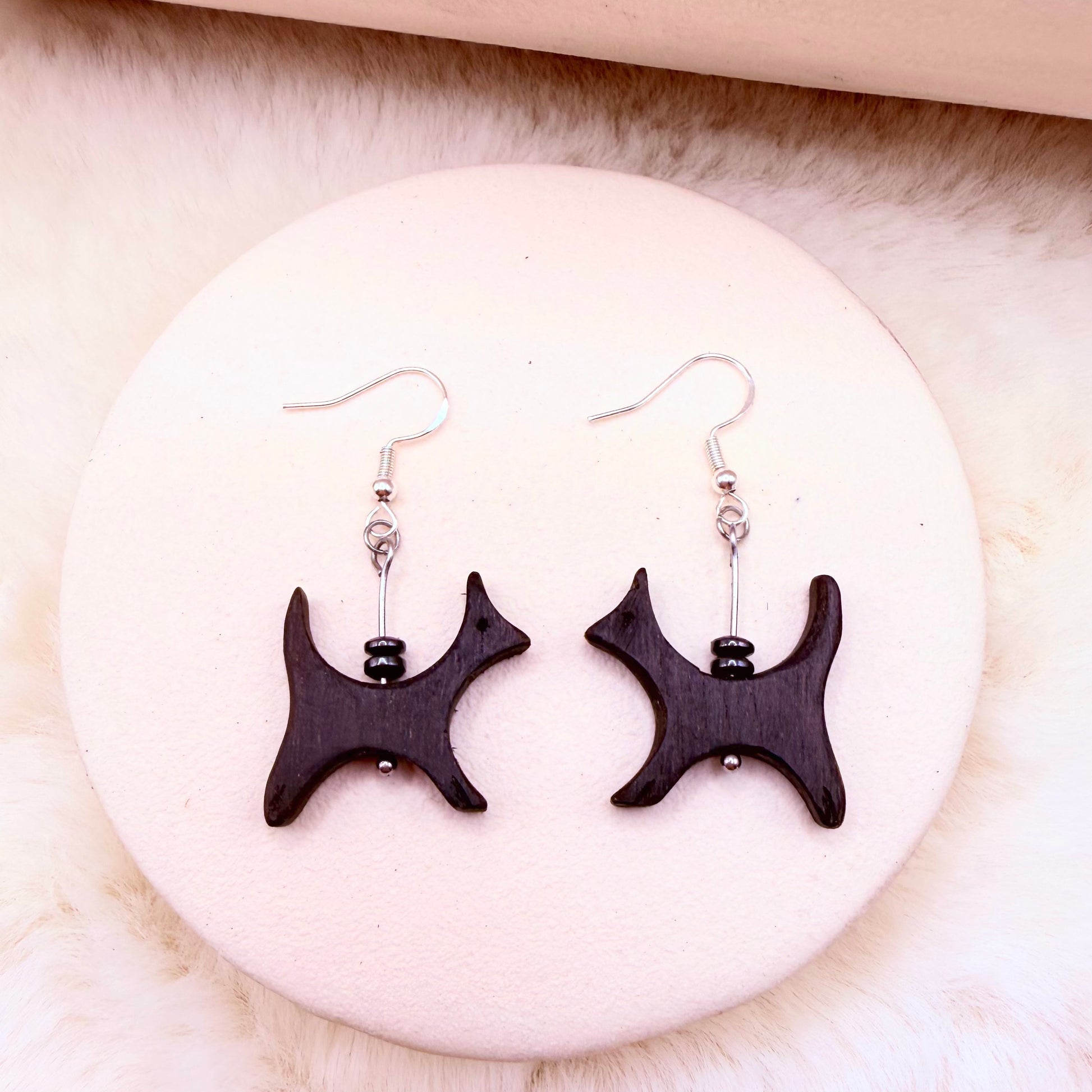 Artisan bog oak jewelry with minimalist modern cat shape.