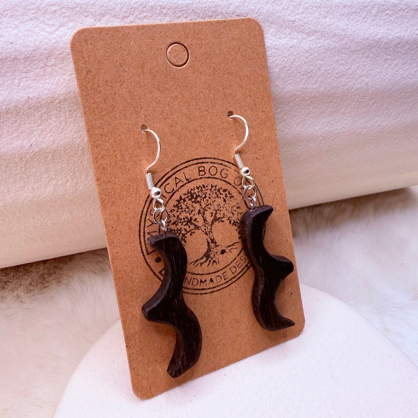 Dark wooden earrings crafted from ancient bog oak