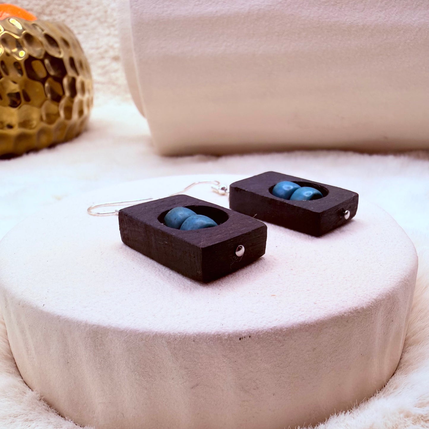 Close-up of natural bog oak and blue Howlite dangle earrings with stainless steel findings
