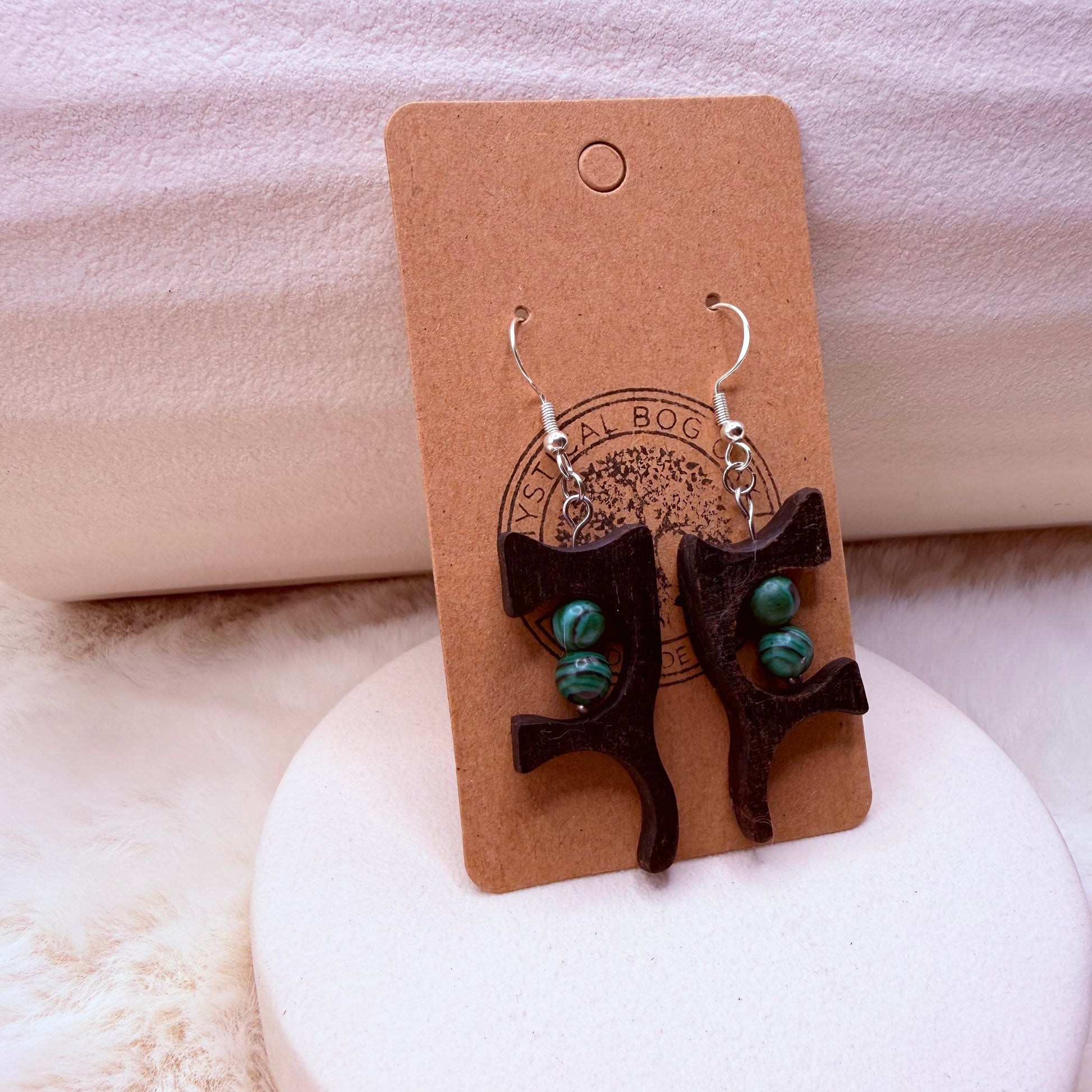 Close-up of natural malachite stone set in dark bog oak wood earrings