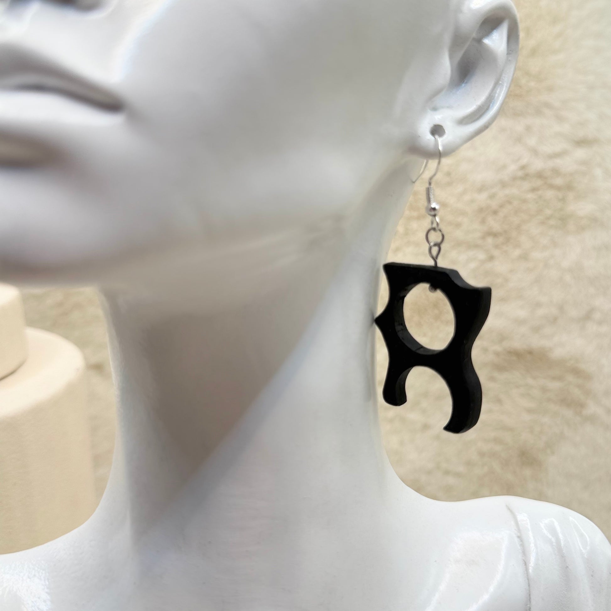 Lightweight black wood earrings with stainless steel findings shown close