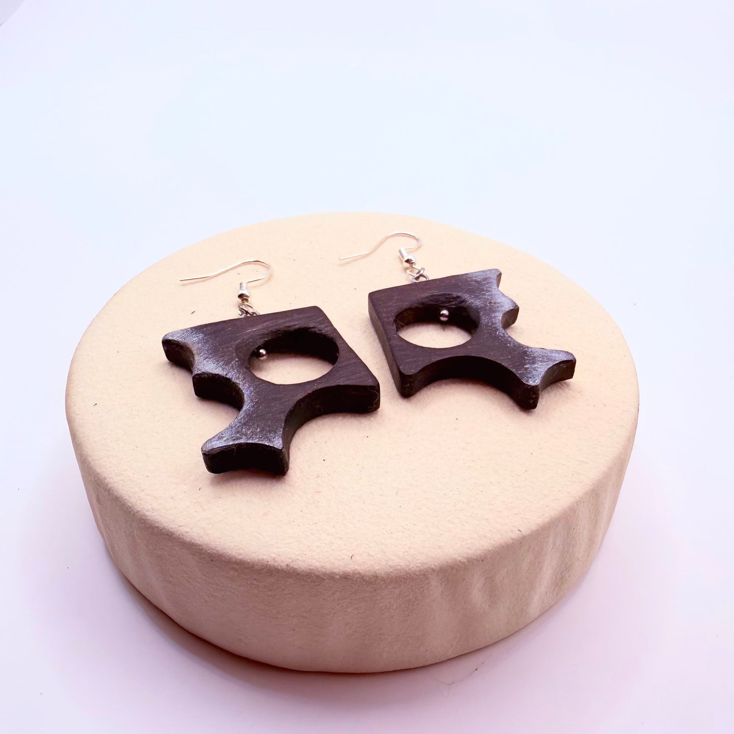 Dark wood sculptural earrings with organic grain pattern