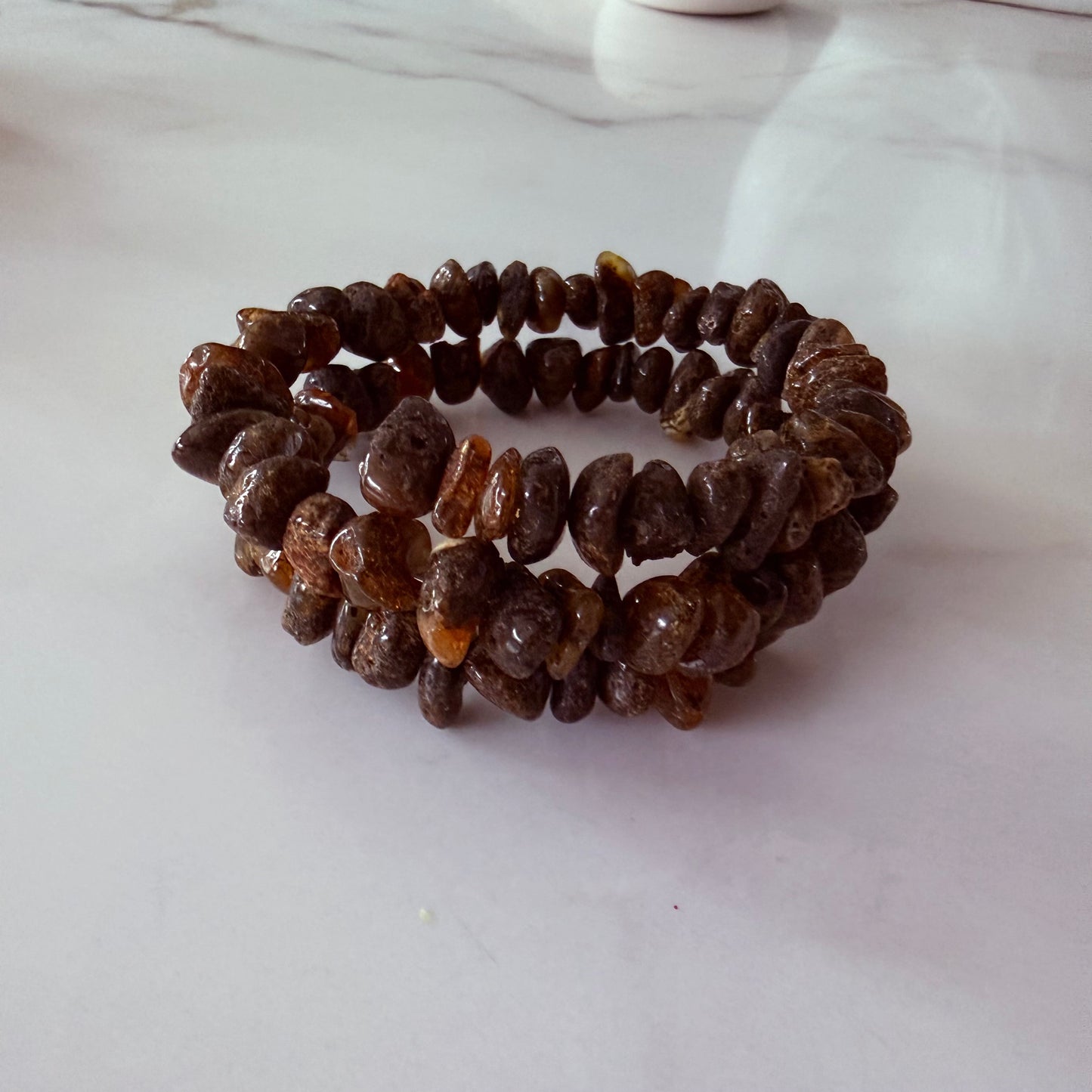 Brown beaded bracelet on a light gray surface