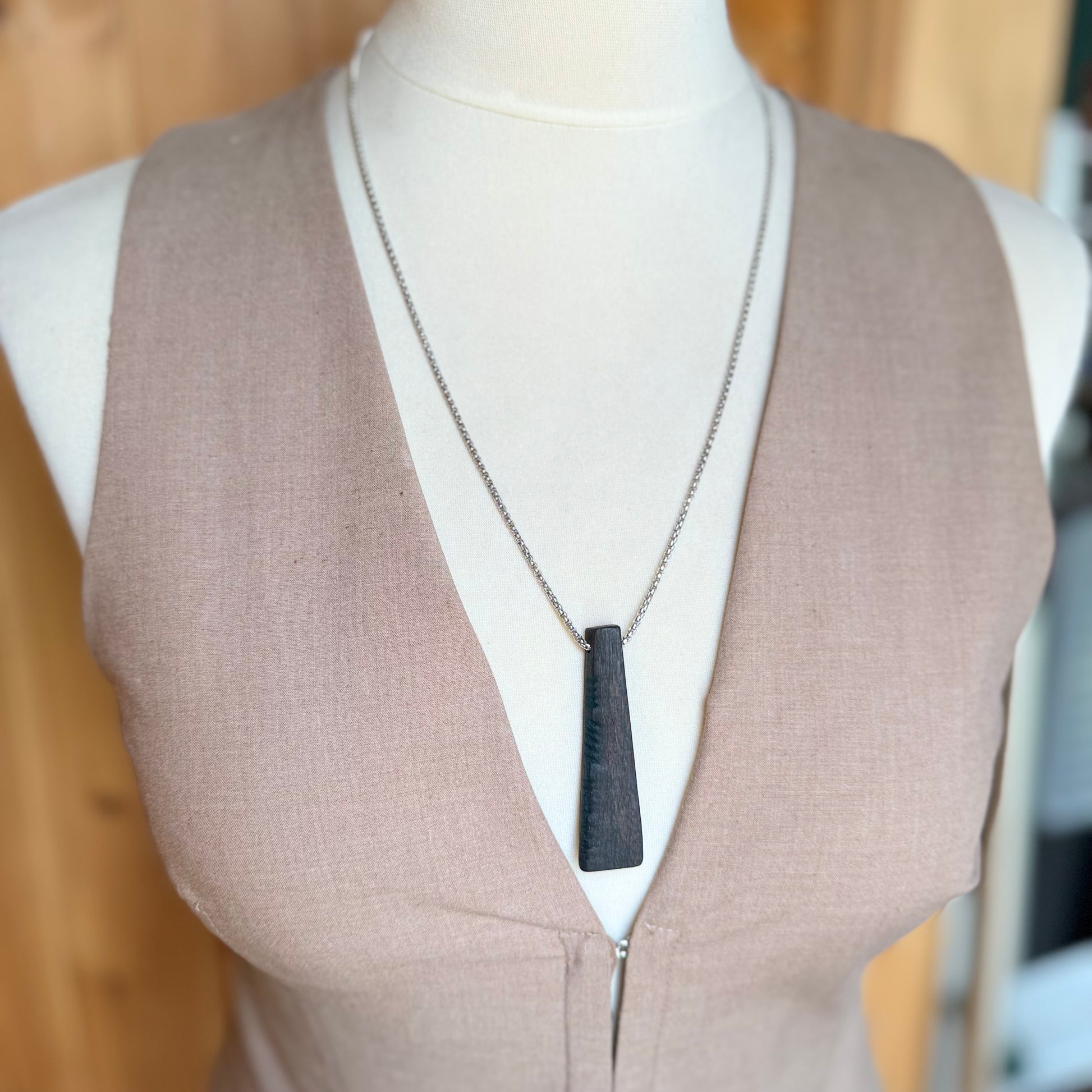 bog oak pendant worn on model necklace close up