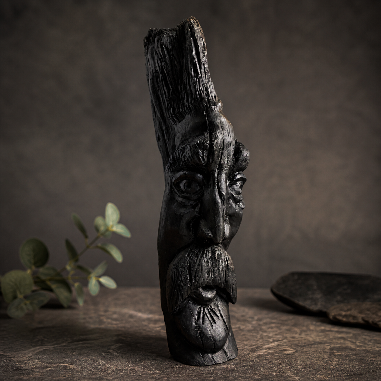 Hand-carved face sculpture in ancient Irish bog wood, front view showing detailed facial features and texture
