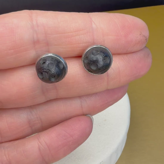 Ancient wood jewelry, black wood stud earrings displayed on minimalistic surface