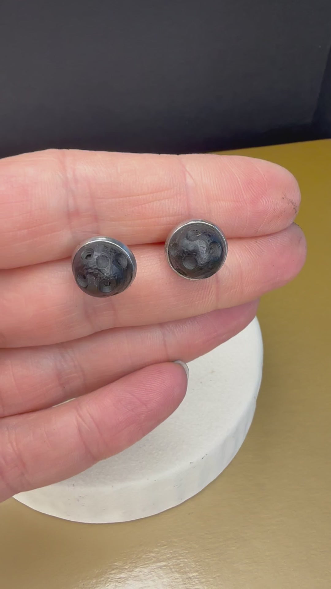 Ancient wood jewelry, black wood stud earrings displayed on minimalistic surface