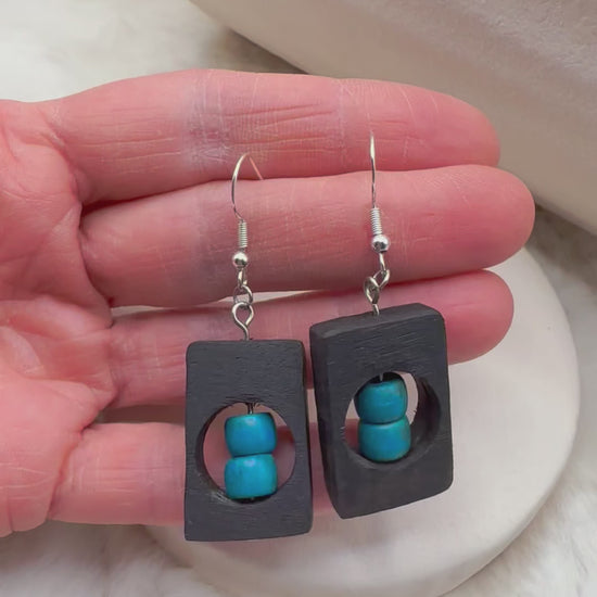 Artisan-crafted bog oak earrings paired with polished blue Howlite beads