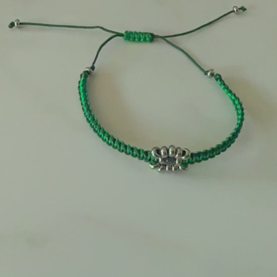 Designed with an adjustable sliding knot closure, this bracelet