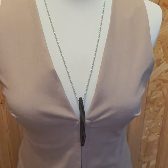 Ancient bog oak pendant symbolizing grounding and connection to nature. Handcrafted, rustic, meaningful jewelry with soul.
