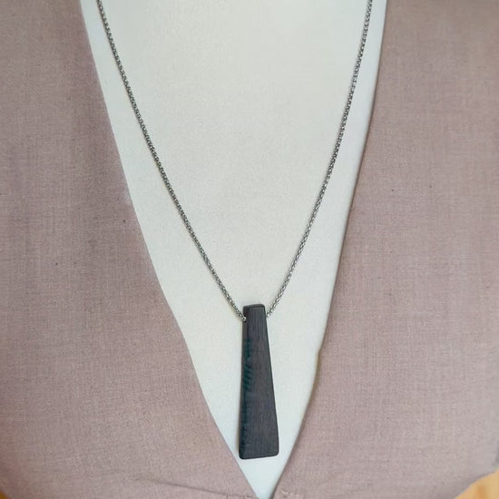 bog oak pendant worn on model necklace close up