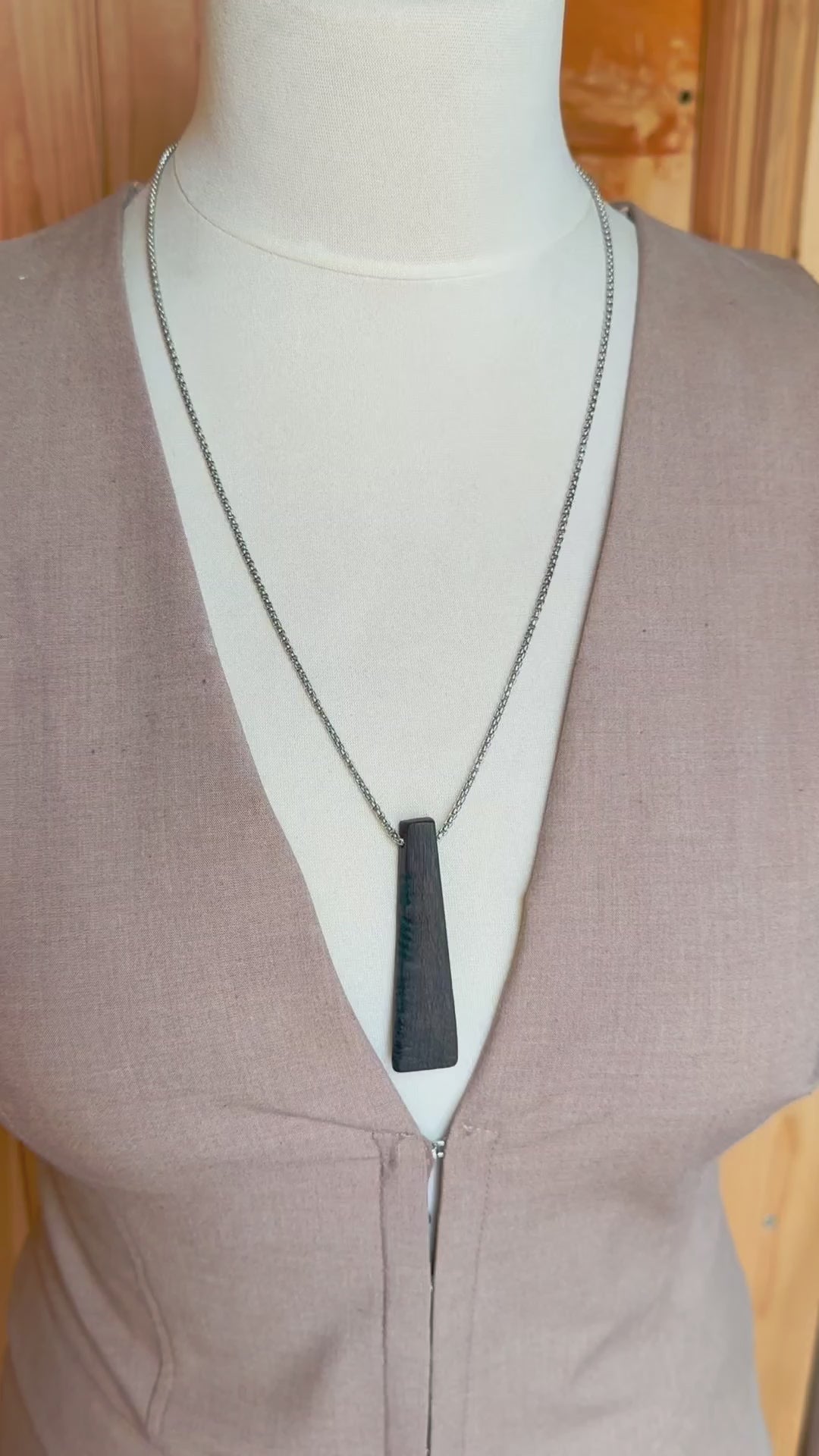 bog oak pendant worn on model necklace close up