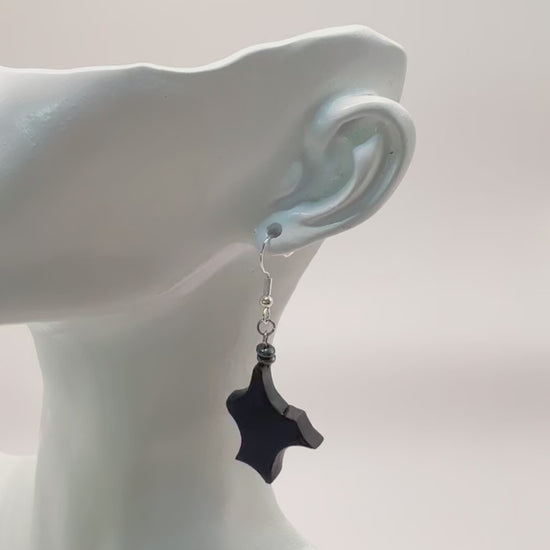 Close-up on the unique grain and texture of the ancient Irish Bog Oak in these earrings.