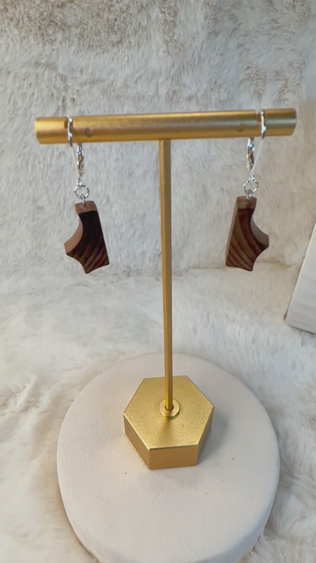 Close-up of handcrafted bog wood earrings, showcasing the natural grain and rich tones of the wood, with sterling silver hooks.