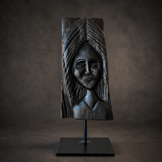 One-of-a-kind bog oak sculpture of a serene female figure with closed eyes, mounted on a black stand